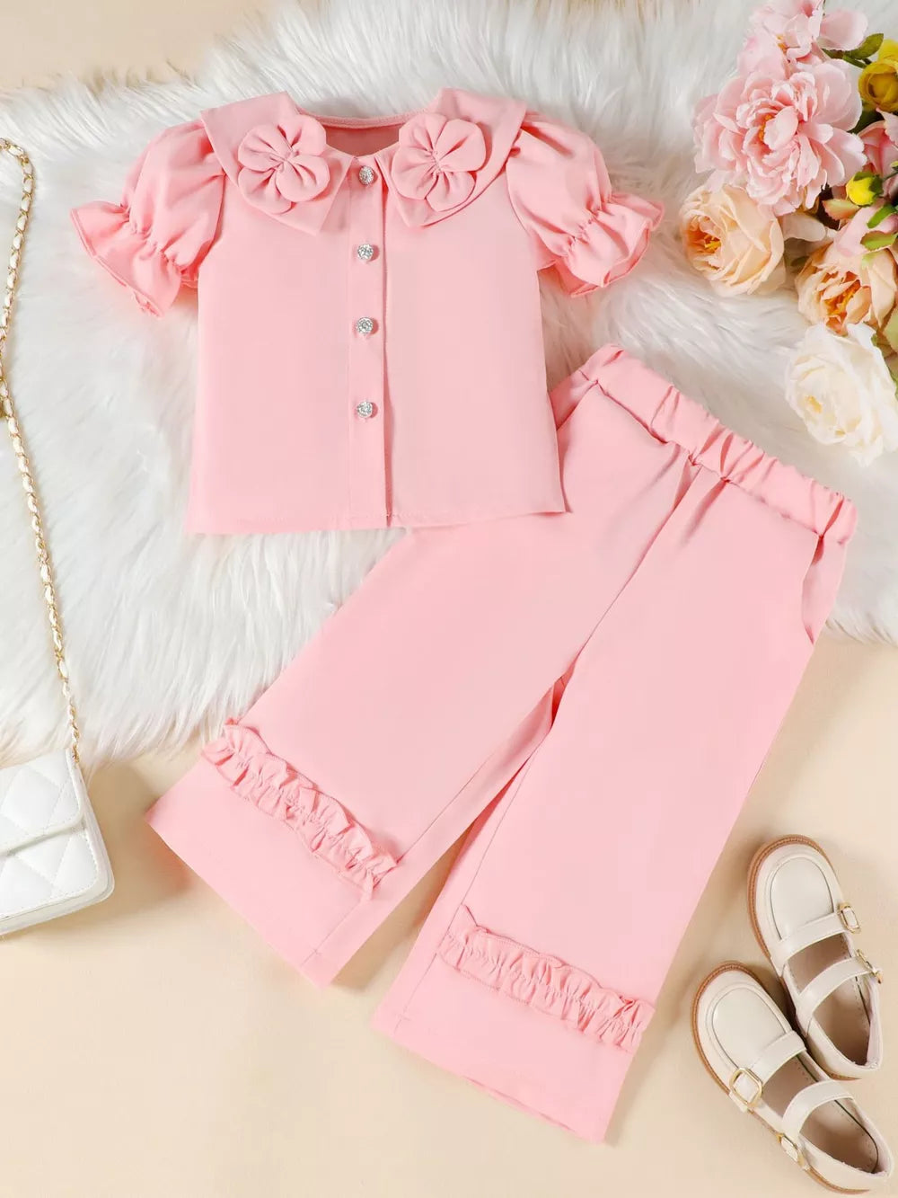 Pink toddler set with floral collar, ruffled sleeves, and ruffled pants.