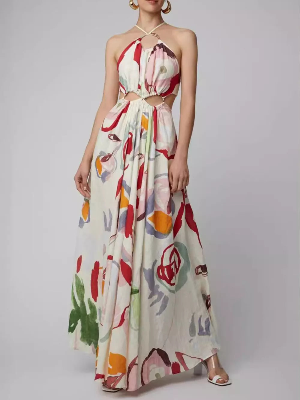 Abstract print halter maxi dress with cut-outs on a cream background.