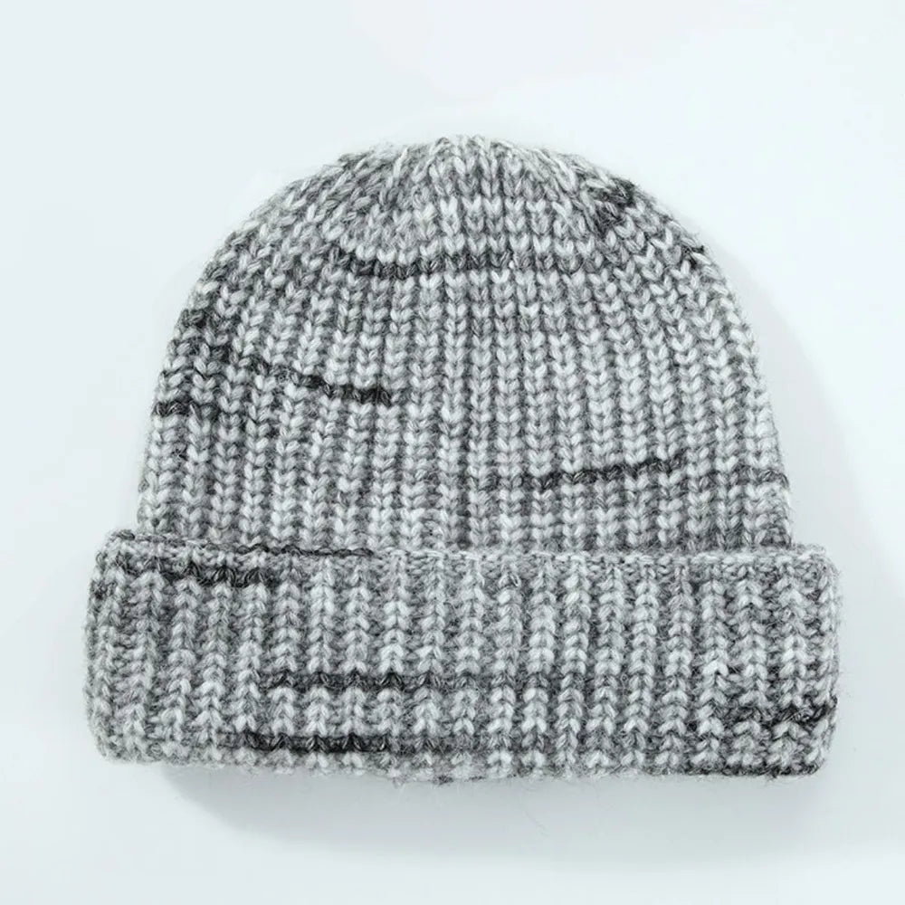 Textured mélange ribbed beanie in gray with dark stripes and a cuffed brim.
