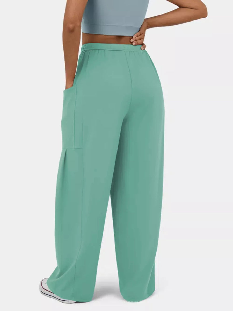 Light Green maternity pants with wide legs and pockets, styled casually.