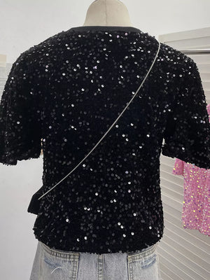 Black sequin t-shirt with crew neck and short sleeves, embellished with iridescent sequins.