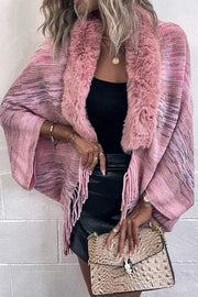 Textured knit cape in Dusty Pink with faux fur collar and fringe detail.