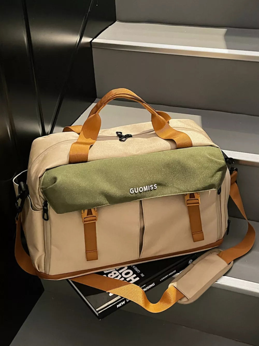 Chic nylon travel bag with olive flap and tan accents, dual top handles, and adjustable shoulder strap.