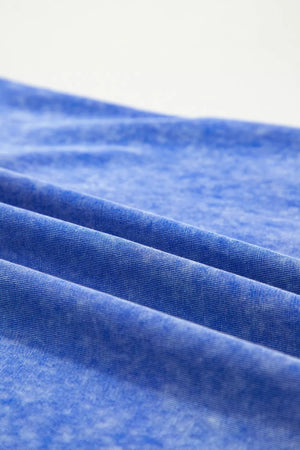 Blue mineral wash cotton t-shirt with a distressed look and subtle texture.