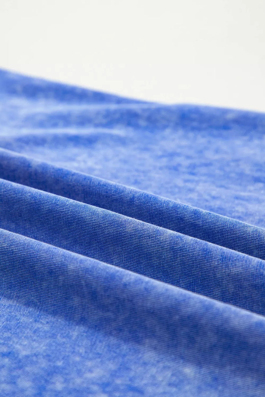 Blue mineral wash cotton t-shirt with a distressed look and subtle texture.