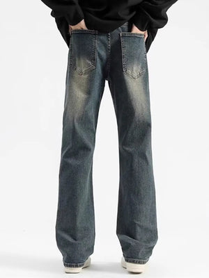 Men's relaxed fit jeans in heritage wash denim with distressed details.