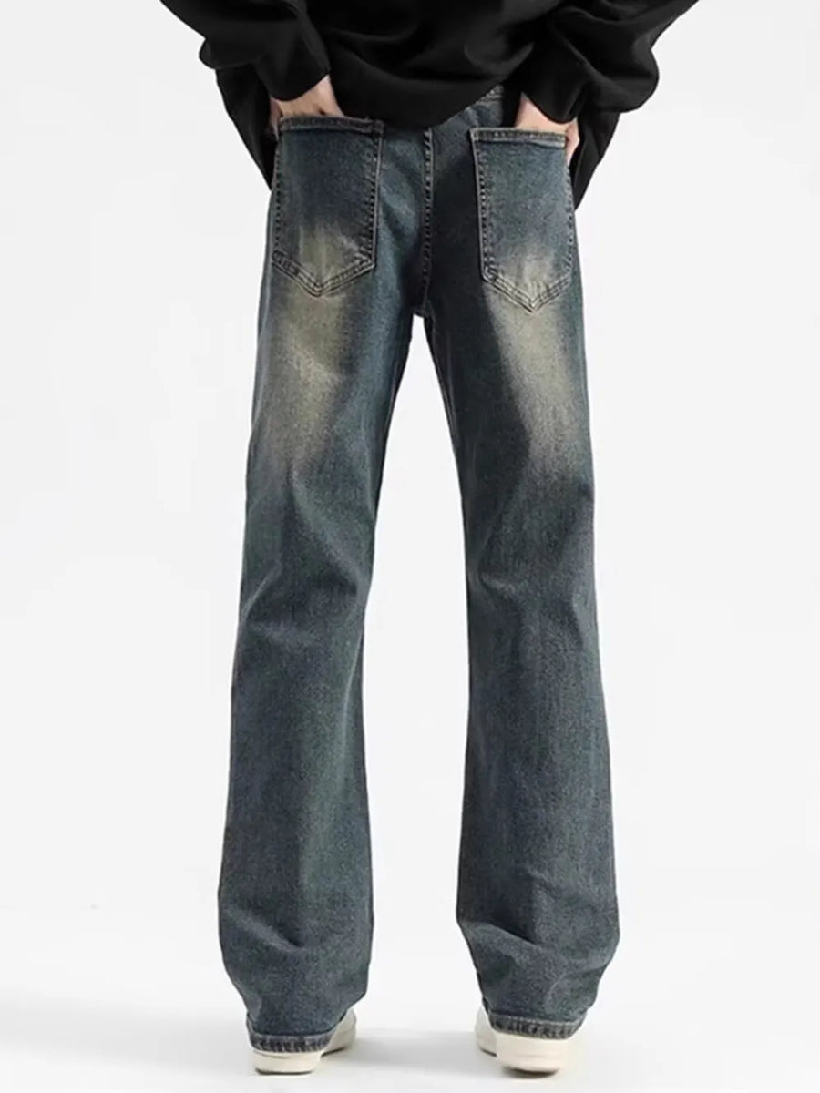 Men's relaxed fit jeans in heritage wash denim with distressed details.