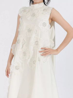 White sleeveless dress with floral appliques and sequin details, high neckline