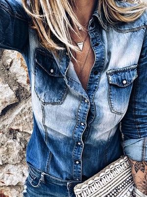 Faded denim button-down shirt with chest pockets and a casual fit.
