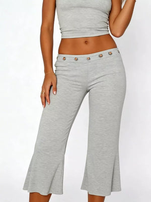 Light gray flared hem capri pants with button detail at the waist.