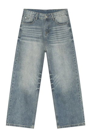 Oversized baggy wash denim trousers in medium blue with whiskering details.