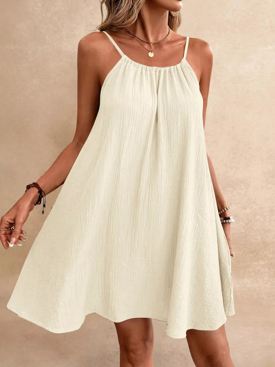 Spaghetti strap gauze dress in apricot with a gathered neckline and A-line skirt.