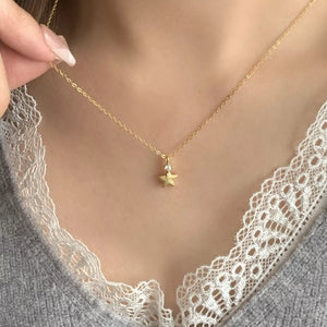 necklace in gold with geometric and star pendant