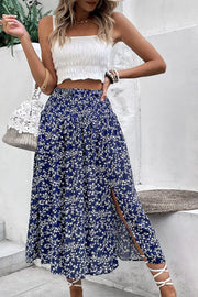 Ditsy floral midi skirt in blue with a high slit and smocked waist.