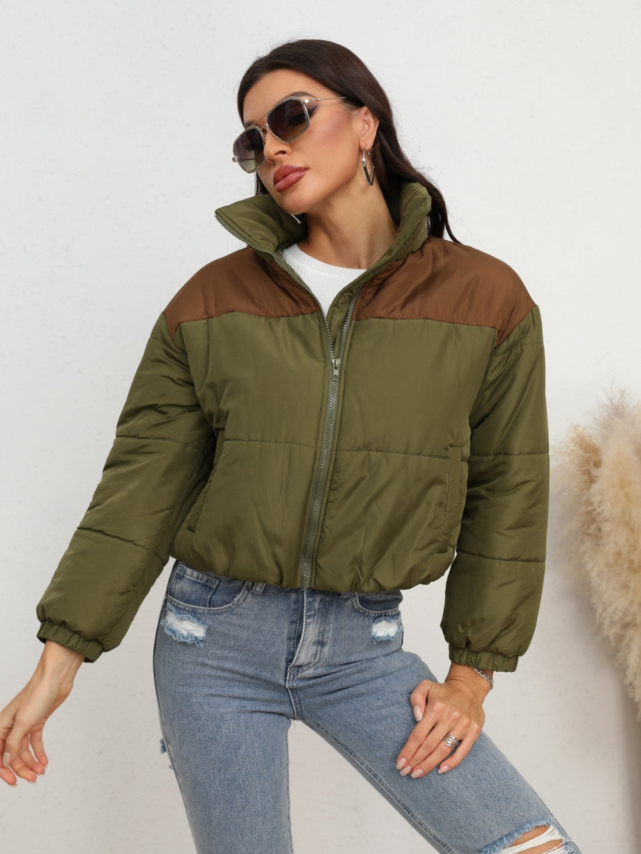 Colorblock cropped puffer jacket in army green with brown accents, full zip, and stand-up collar.