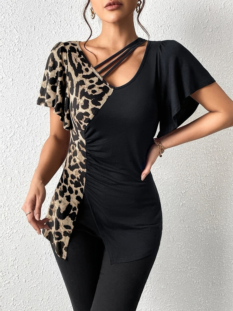 Asymmetric black top with leopard print panel, cutout neckline, and ruched detail.