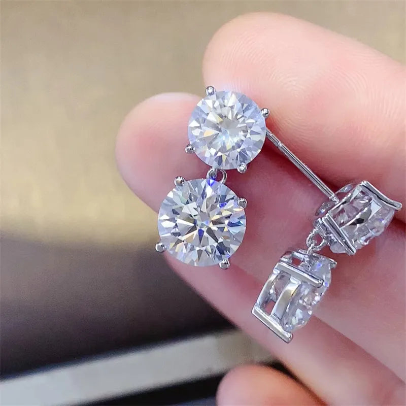 Silver double-drop cubic zirconia stud earrings with round and baguette stones.