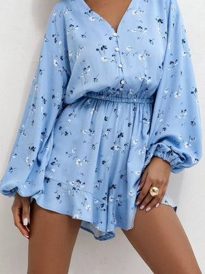 Blue floral v-neck romper with cinched waist and button front.