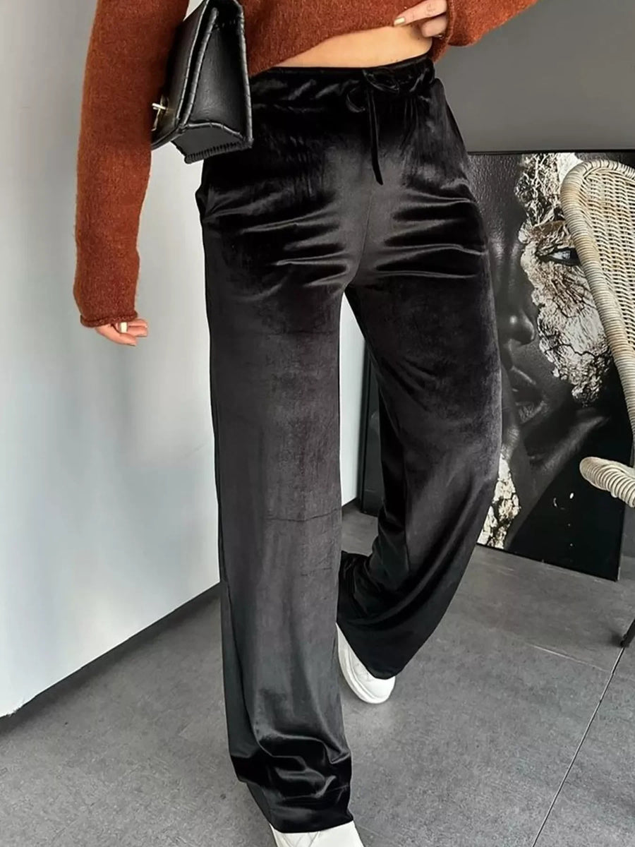Black velvet tied wide-leg trousers with a comfortable fit.