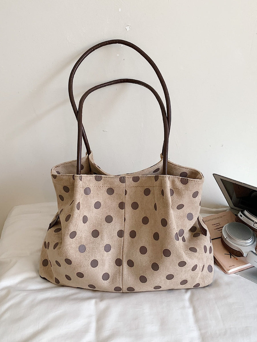 dark brown shoulder bag featuring shoulder straps and polka dot