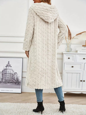 Off-white hooded longline coat with cable knit texture and fuzzy finish.