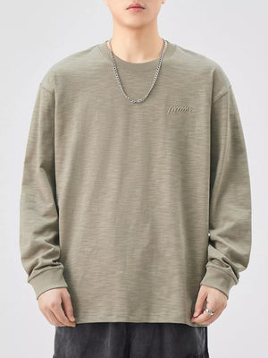 Oversized Khaki Color cotton long-sleeve tee with subtle embroidered logo detail.