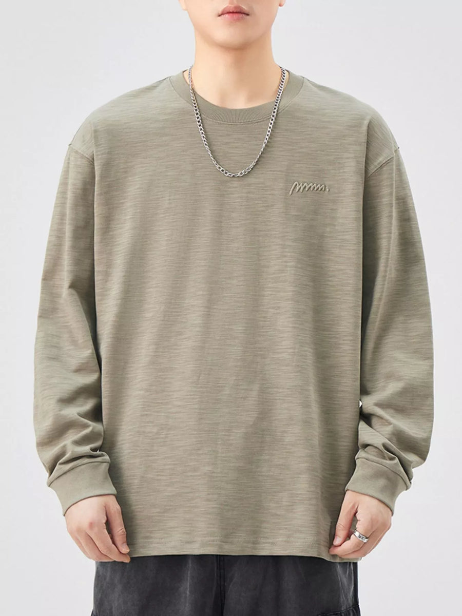 Oversized Khaki Color cotton long-sleeve tee with subtle embroidered logo detail.