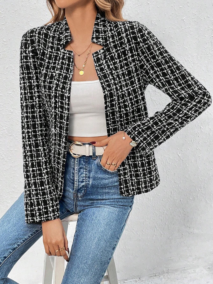 Black and white tweed open-front blazer with a plaid pattern, worn with a white top and jeans.