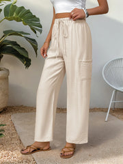 Chic tan waist-tie flare trousers with cargo pocket detail.