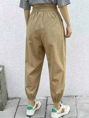Khaki relaxed fit harem joggers with elastic waist and cuffs, featuring side pockets.