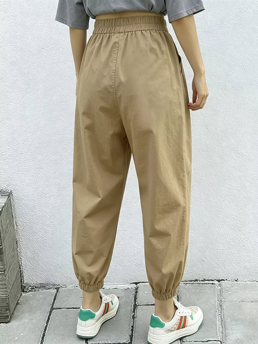 Khaki relaxed fit harem joggers with elastic waist and cuffs, featuring side pockets.