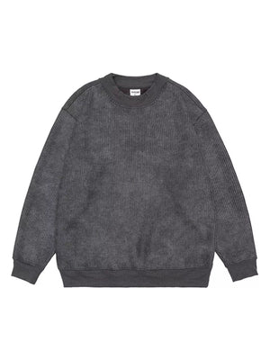 Dark gray oversized corduroy sweatshirt with round neck and ribbed cuffs and hem.