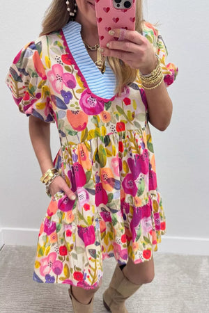 Vibrant floral cotton mini dress with tiered skirt, puff sleeves, and blue striped neckline.
