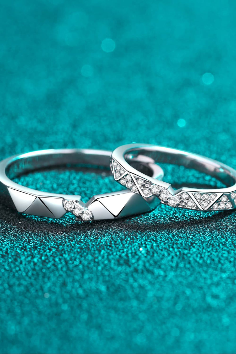 Geometric rhodium pavé ring set with cubic zirconia accents on a teal sparkly background