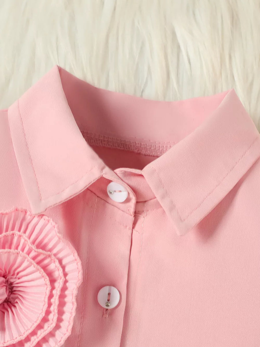 Pink toddler outfit with floral appliqué and decorative buttons