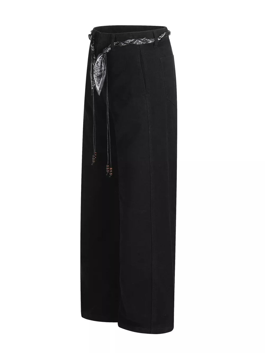 Black maternity pants with wide legs and a patterned belt with beaded ties.