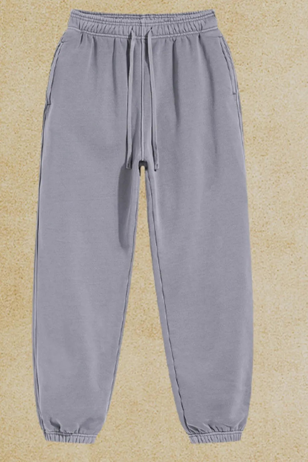 Gray relaxed fit drawstring sweatpants with cuffed ankles and side pockets.