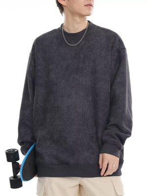 Dark gray oversized corduroy sweatshirt with round neck and ribbed cuffs and hem.