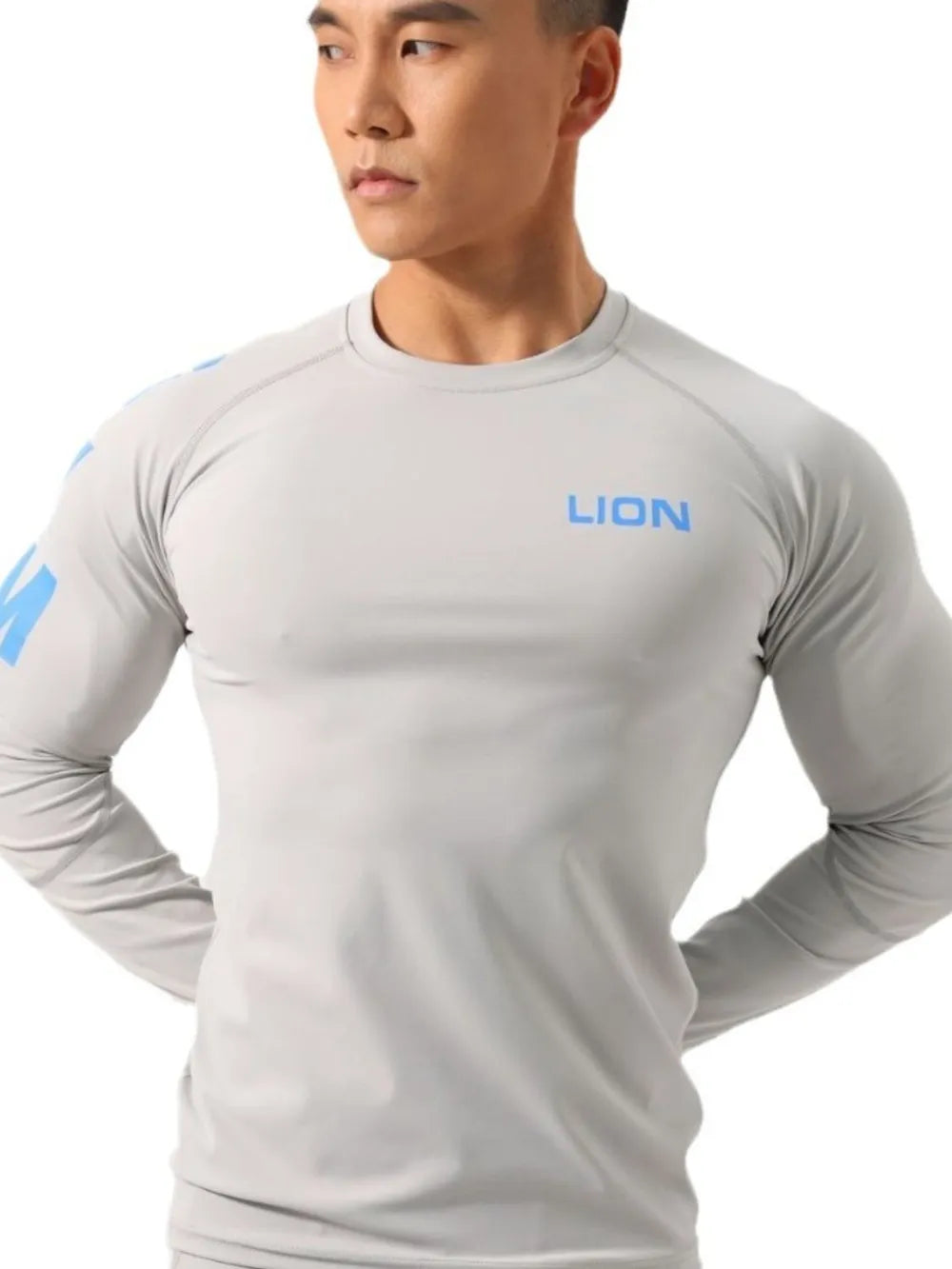 Gray performance raglan sleeve tee with blue logo on chest and sleeve.