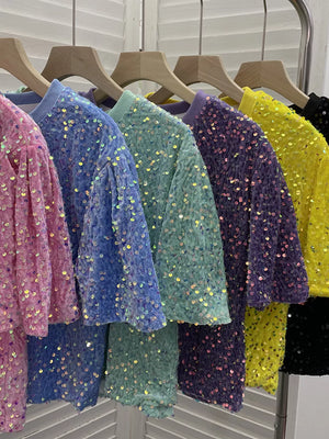 Iridescent sequin embellished t-shirts in pink, blue, green, purple, yellow, and black.
