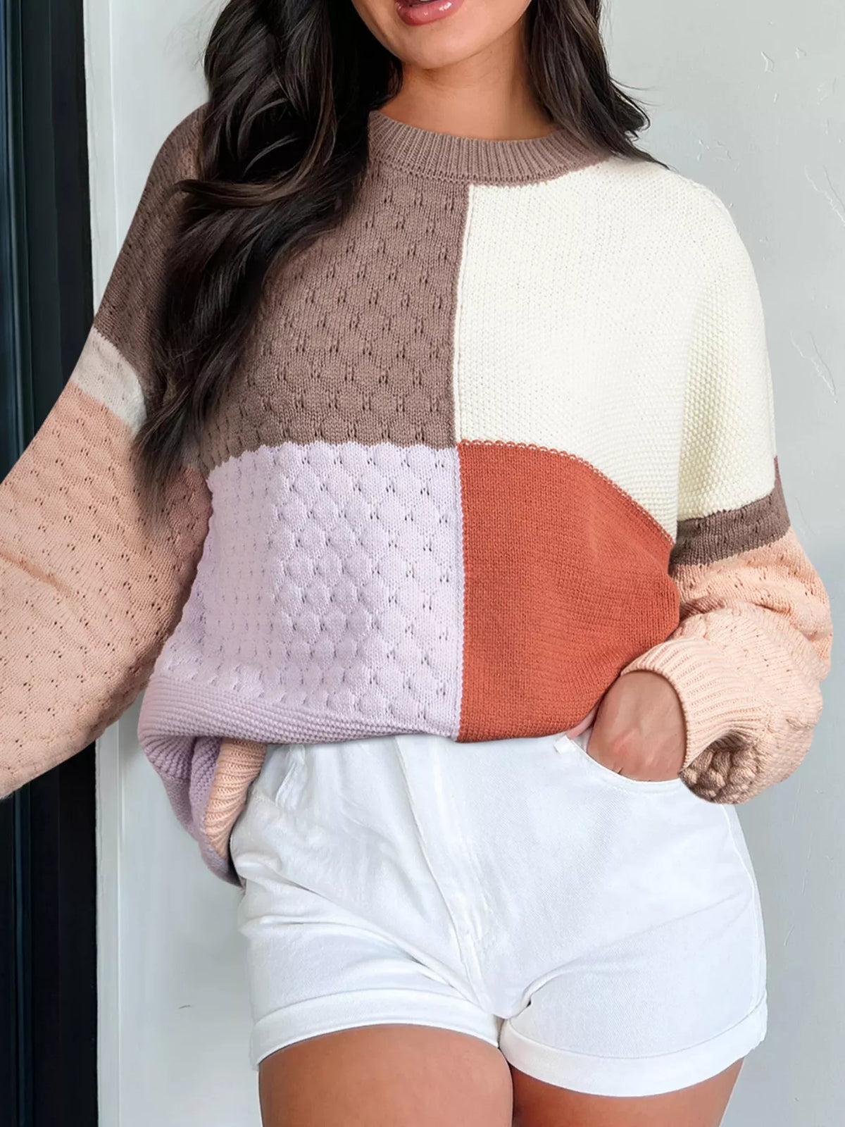 Multicolor patchwork knit sweater with textured diamond and rib patterns.