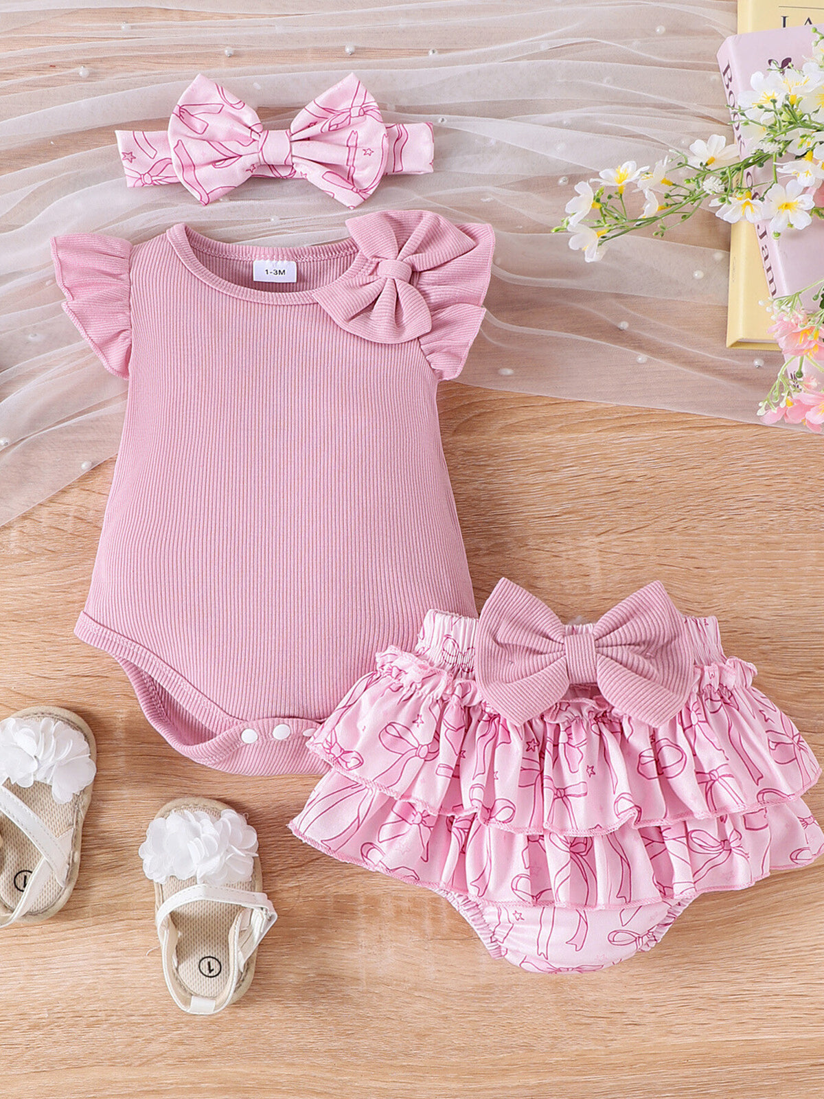 Pink cotton baby bodysuit with ruffled sleeves and bowknot, paired with a bowknot print ruffle skort.