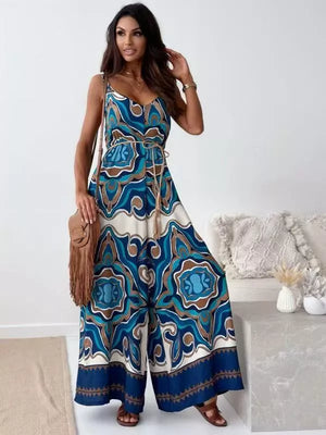 Paisley patterned wide-leg romper in Peacock Blue with tie waist and spaghetti straps.