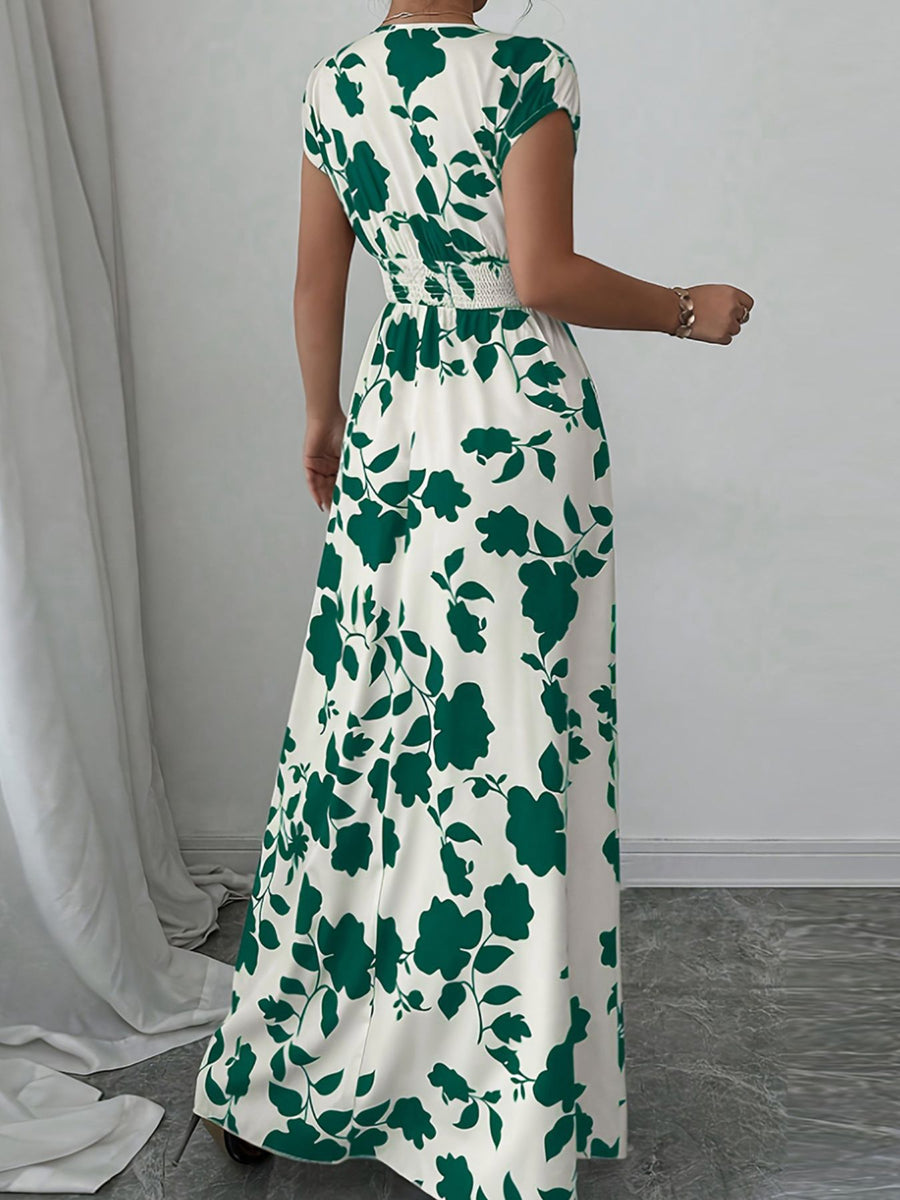 Maxi dress with green floral print, cap sleeves, and smocked waist.
