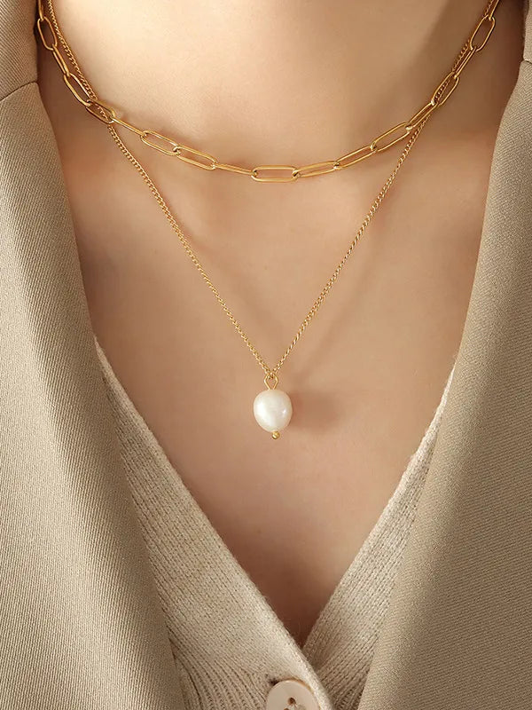 Gold paperclip chain layered necklace with a single pearl pendant.