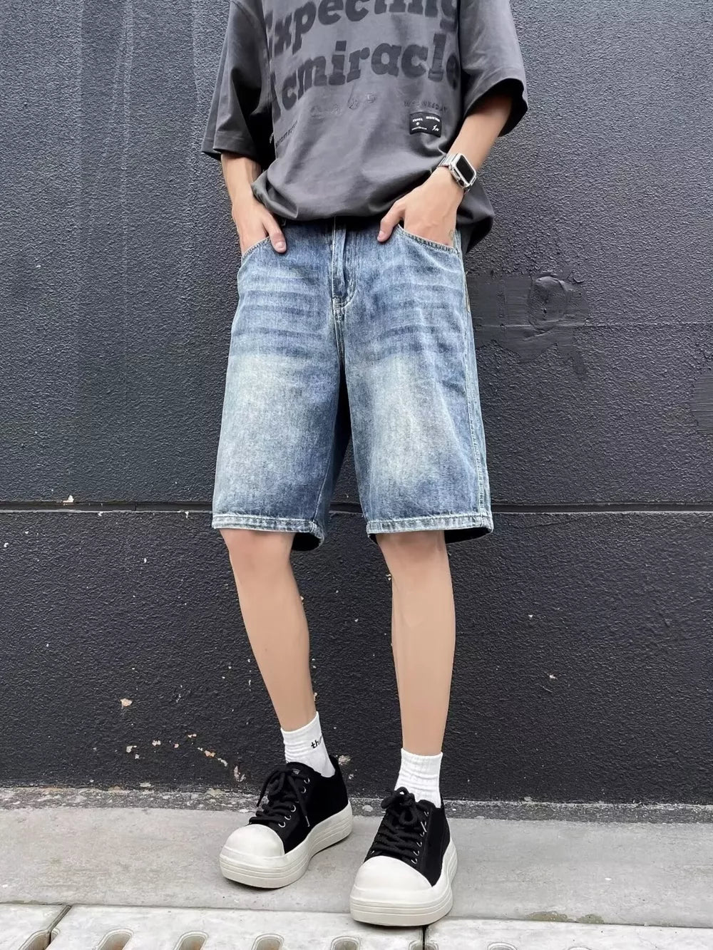Men's relaxed fit blue denim shorts with whiskering and a vintage wash.