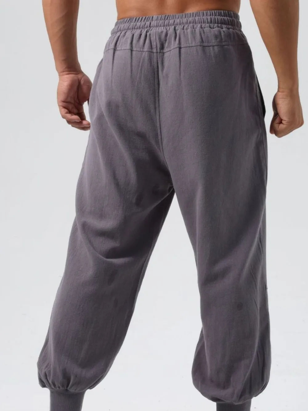 Relaxed fit dark gray joggers with adjustable waistband and seam details.