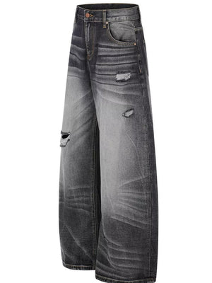 Men's black distressed wide-leg jeans with ripped details and faded wash.
