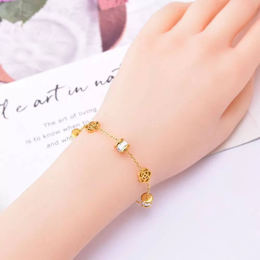 bracelet in gold featuring flower charms and straight fit