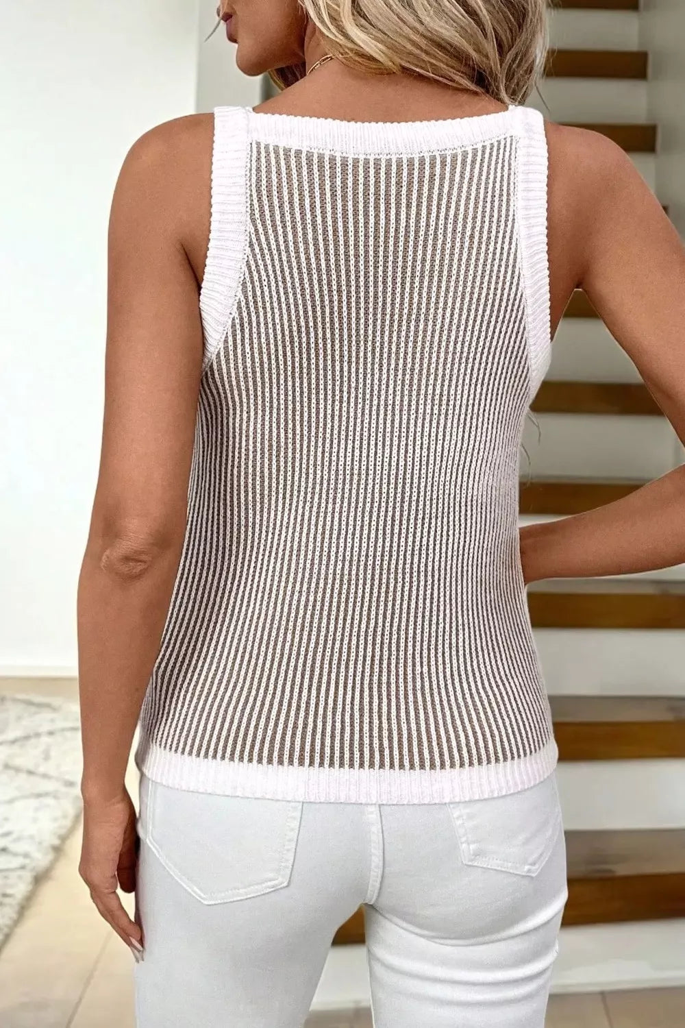 Ribbed knit sweater vest with contrast trim and vertical stripes.